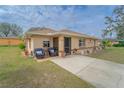 Inviting front porch with comfortable seating and a view of the well-manicured front yard at 160 Clay Cut Cir, Haines City, FL 33844