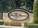 Close up of Tuscany Preserve community sign with flowering bushes in the foreground at 1617 Cumin Dr, Kissimmee, FL 34759