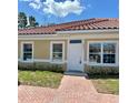 Charming single-story home featuring a red tile roof, freshly landscaped yard, and brick walkway at 1617 Cumin Dr, Kissimmee, FL 34759