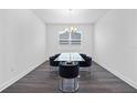 Simple dining room with dark hardwood floors and a glass table at 1933 Burgundy Dr, Minneola, FL 34715