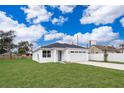 New construction home with a white exterior, gray door and attached garage at 2706 Alamo Dr, Orlando, FL 32805