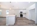 Modern kitchen with white cabinets, stainless steel appliances, and quartz countertops at 2706 Alamo Dr, Orlando, FL 32805