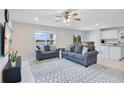 Bright living room with two sofas, a rug, and a view of the lake at 5302 Royal Point Ave, Kissimmee, FL 34746