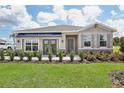 House exterior featuring a stylish awning and landscaping at 5513 Hanover Square Dr, St Cloud, FL 34771