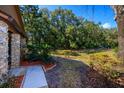 Landscaped front yard with mature trees and pathway to the home's entrance at 596 Albany Pl, Longwood, FL 32779