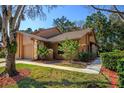 Charming home featuring a two-car garage, well-maintained lawn, and mature landscaping at 596 Albany Pl, Longwood, FL 32779