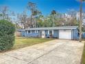 Newly renovated home with a spacious driveway and lush green lawn at 608 Powers Ave, Port Orange, FL 32127