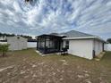 Screened patio, shed, and grassy backyard at 800 Woodlark Dr, Davenport, FL 33897