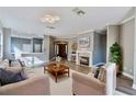 Elegant living room featuring a cozy fireplace, neutral decor, and plenty of natural light at 10812 Woodchase Cir, Orlando, FL 32836