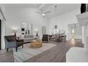 Bright living room with a fireplace, ceiling fan, and luxury vinyl flooring at 123 Golf Club Dr, Longwood, FL 32779