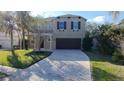 Beautiful two-story home with a paved driveway, lovely landscaping, and an attached two-car garage at 13124 Oulton Cir, Orlando, FL 32832