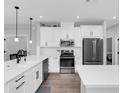 Modern kitchen with white cabinets, stainless steel appliances, and quartz countertops at 1401 Lone Feather Trl, Winter Park, FL 32792