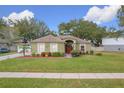 One-story house with green exterior,red door,landscaped yard at 1511 Dunn Cove Dr, Apopka, FL 32703