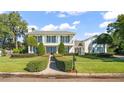 Stunning two-story home with a charming front entrance and manicured lawn at 1522 Lake Knowles Cir, Winter Park, FL 32789