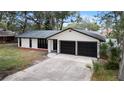 Newly renovated home with driveway and mature trees at 1523 N Beach St, Ormond Beach, FL 32174