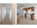 Spacious kitchen with oak cabinets, white appliances, and granite countertops at 1613 Lansfield Ave, Deltona, FL 32738