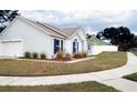 Light blue house with a white garage door and nicely manicured lawn at 1621 Slash Pine Pl, Oviedo, FL 32765