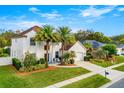 Two-story house with white exterior, palm trees, and landscaped yard at 1706 Tiverton St, Winter Springs, FL 32708