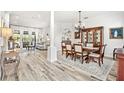 Formal dining room with wood table, chandelier, and access to living room at 1706 Tiverton St, Winter Springs, FL 32708