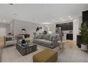 Open living room featuring a gray couch and dark kitchen cabinets at 1720 Columbus Path, St Cloud, FL 34771