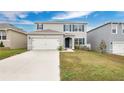 Two-story house with gray siding, white garage door, and landscaped lawn at 1794 Hackberry St, Clermont, FL 34715