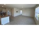 Open-concept living room with tile floors and kitchen island at 1794 Hackberry St, Clermont, FL 34715