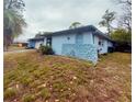 Side view of light blue house with stone accents at 1854 Sepalwood Ct, Orlando, FL 32818