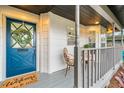 Eye-catching blue front door with a welcoming wreath, adding charm to the home's entrance at 3012 Amherst Ave, Orlando, FL 32804