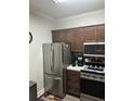 Stainless steel appliances and wood cabinets in this galley kitchen at 3367 S Kirkman Rd # 1116, Orlando, FL 32811