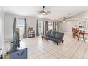 Spacious living room with tile floors and a comfortable couch at 3418 Gator Bay Creek Blvd, St Cloud, FL 34772