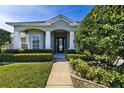 House exterior showcasing a front entrance with landscaping and walkway at 346 Hickory Springs Ct, Debary, FL 32713