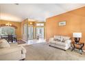 Living room with light beige carpet and walls, and a comfortable couch at 346 Hickory Springs Ct, Debary, FL 32713