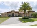 Beautiful single-story Mediterranean-style home with tile roof, lush lawn, and a palm tree at 3764 Farm Bell Pl, Lake Mary, FL 32746