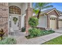 Inviting front entrance with a white door and brick columns at 3838 Gatlin Place Cir, Orlando, FL 32812