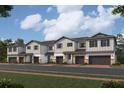 Modern townhome with gray exterior and attached garage at 4299 Campsite Loop, Orlando, FL 32824