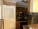 Kitchen features stainless steel appliances and wood cabinets at 4653 Cason Cove Dr # 2713, Orlando, FL 32811