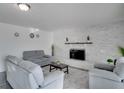 Bright living room featuring a modern fireplace and comfortable seating at 5005 Kipp Pl, Orlando, FL 32808