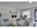 Bright living room featuring a modern fireplace and comfortable seating at 5005 Kipp Pl, Orlando, FL 32808