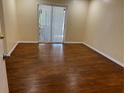 Bright bedroom with wood flooring and sliding glass doors at 5581 Aeolus Way, Orlando, FL 32808