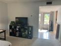 Living room with flat-screen TV and media storage at 6073 Windhover Dr # C04, Orlando, FL 32819