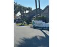 Community entrance sign for Villas, with palm trees and a car at 686 Lake Villas Dr # 686, Altamonte Springs, FL 32701