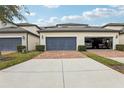 Two-car garage with paved driveway at 9737 Amber Chestnut Way, Winter Garden, FL 34787