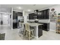 Modern kitchen with dark cabinetry and granite countertops at 9737 Amber Chestnut Way, Winter Garden, FL 34787