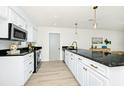 Elegant kitchen with granite countertops, stainless steel appliances, white cabinets, and a modern faucet at 10118 Allenby Ct, Orlando, FL 32821