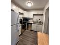 Renovated kitchen with white cabinets and stainless steel appliances at 1142 Grayson Dr, Orlando, FL 32825