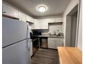 Renovated kitchen featuring modern white cabinets and stainless steel appliances at 1142 Grayson Dr, Orlando, FL 32825