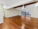 Spacious living area showcasing hardwood floors and sliding glass doors leading to the outdoors at 12331 Warren Rd, Clermont, FL 34711