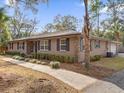 Tan house with stone accents, landscaping, and a spacious lawn at 126 Se 41St Ave, Ocala, FL 34471