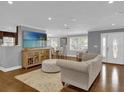 Spacious living room with hardwood floors, comfortable seating, and large TV at 126 Se 41St Ave, Ocala, FL 34471
