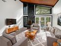 Spacious living room with a fireplace, large windows, and comfortable seating at 14421 Parker Rd, Orlando, FL 32832